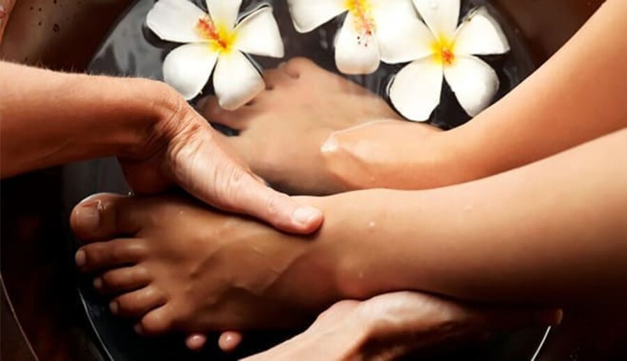 Thai foot massage with frangipani flowers