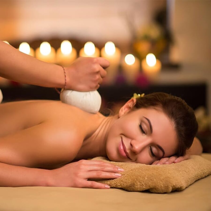 Herbal stamp massage by candlelight